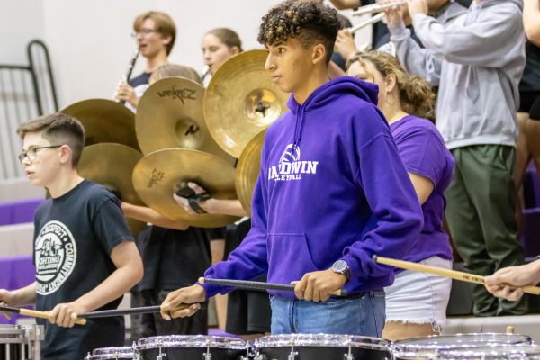 Sophomore Christian Jones plays the drums alongside the band during the pep rally.