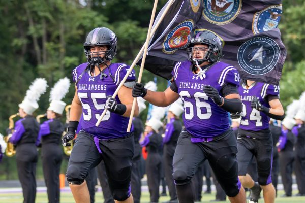 Seniors Nicholas Huschak and Caleb Scheller lead the team out before the game against West Mifflin.