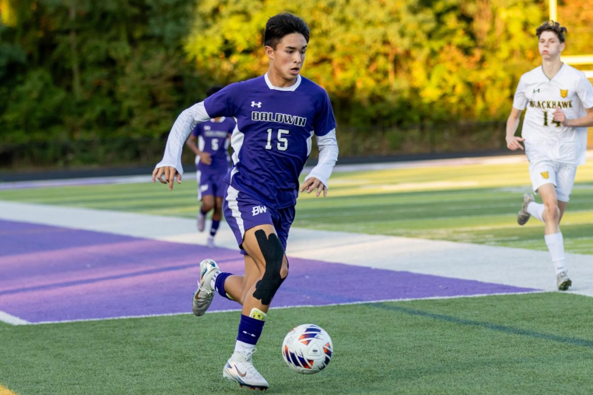 Senior Zach Lieu chases the ball down the field against Blackhawk.