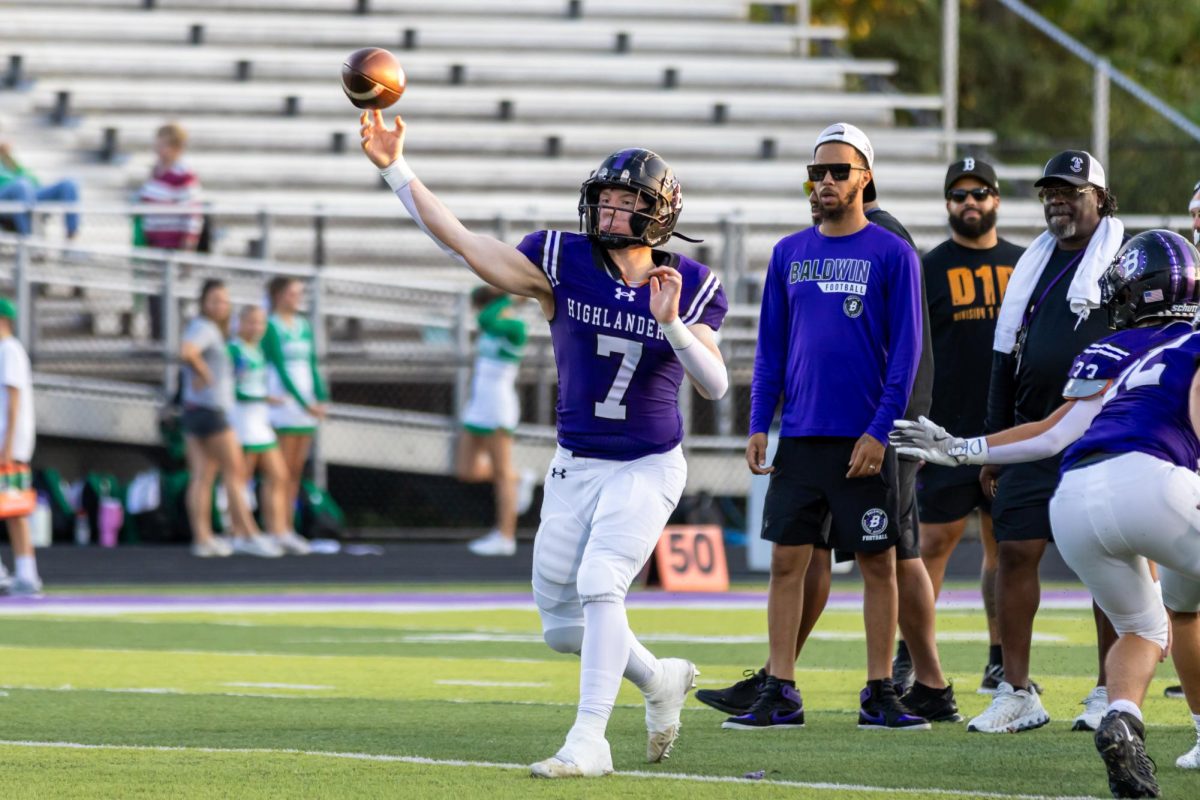 Sophomore Max Galentine throws the ball to a reciever during warmups.