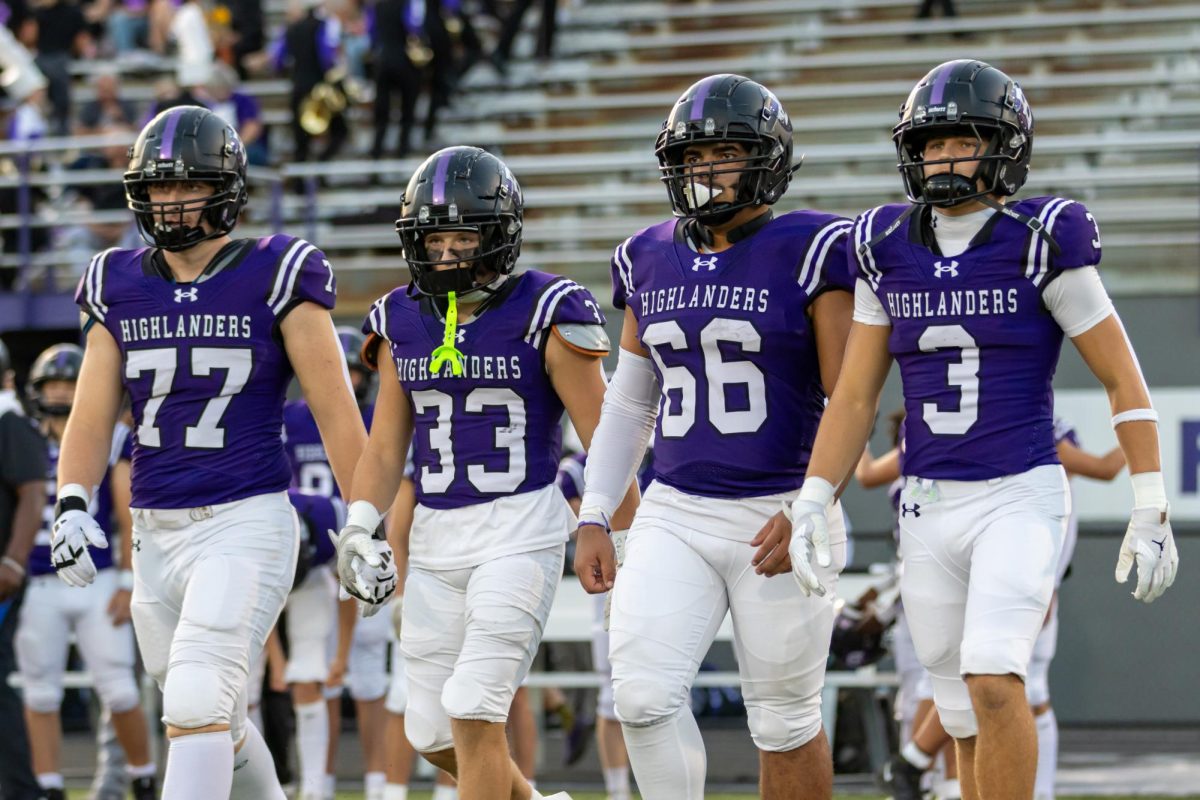 From left, sophomore Dylan Kluczkowski, and seniors Josh Staudt, Caleb Scheller, and Noah Saccani walk out to the center of the field for the coin toss in the South Fayette game.