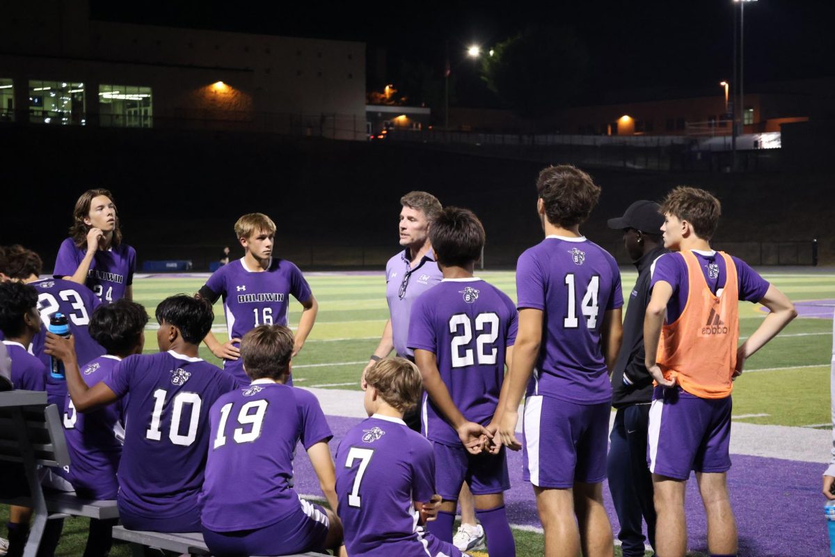 Baldwin Head Coach Edward Child talks to the team during halftime.