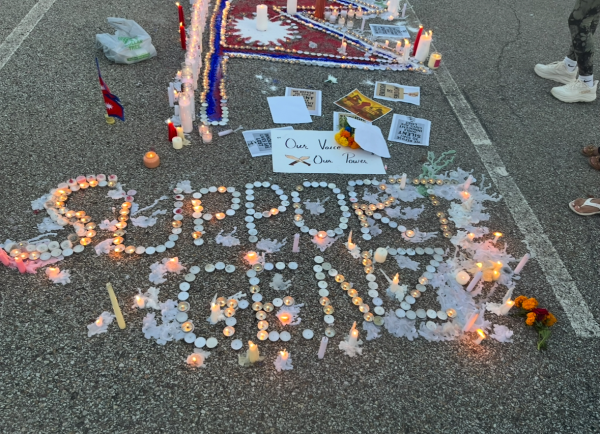 Candles at the Baldwin vigil spell out the words “Support Gen Z.”