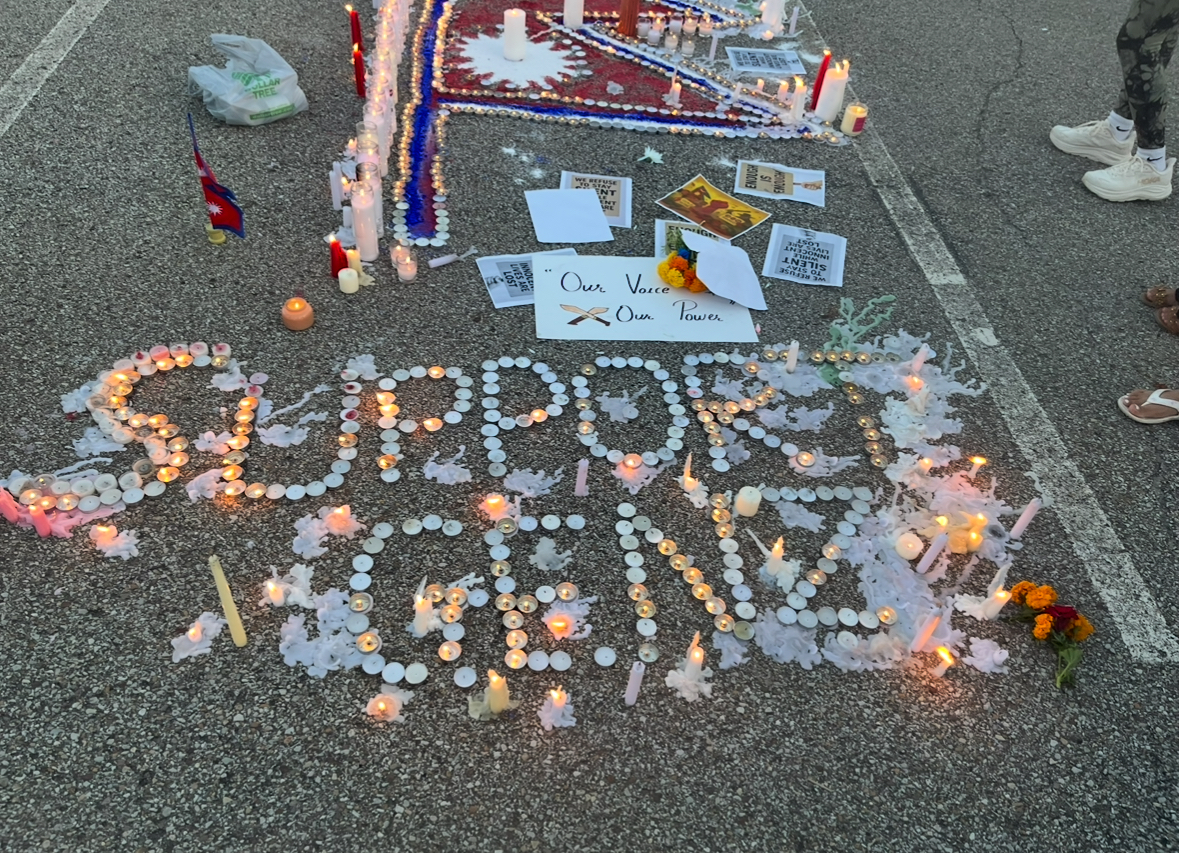 Candles at the Baldwin vigil spell out the words “Support Gen Z.”