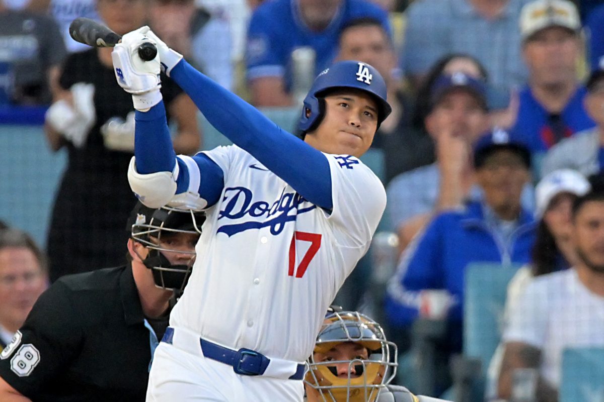 Oct 18, 2025; Los Angeles, California, USA; Los Angeles Dodgers two-way player Shohei Ohtani (17) hits a solo home run during the first inning of game five of the NLCS in the 2025 MLB playoffs against the Milwaukee Brewers at Dodger Stadium. Mandatory Credit: Jayne Kamin-Oncea-Imagn Images