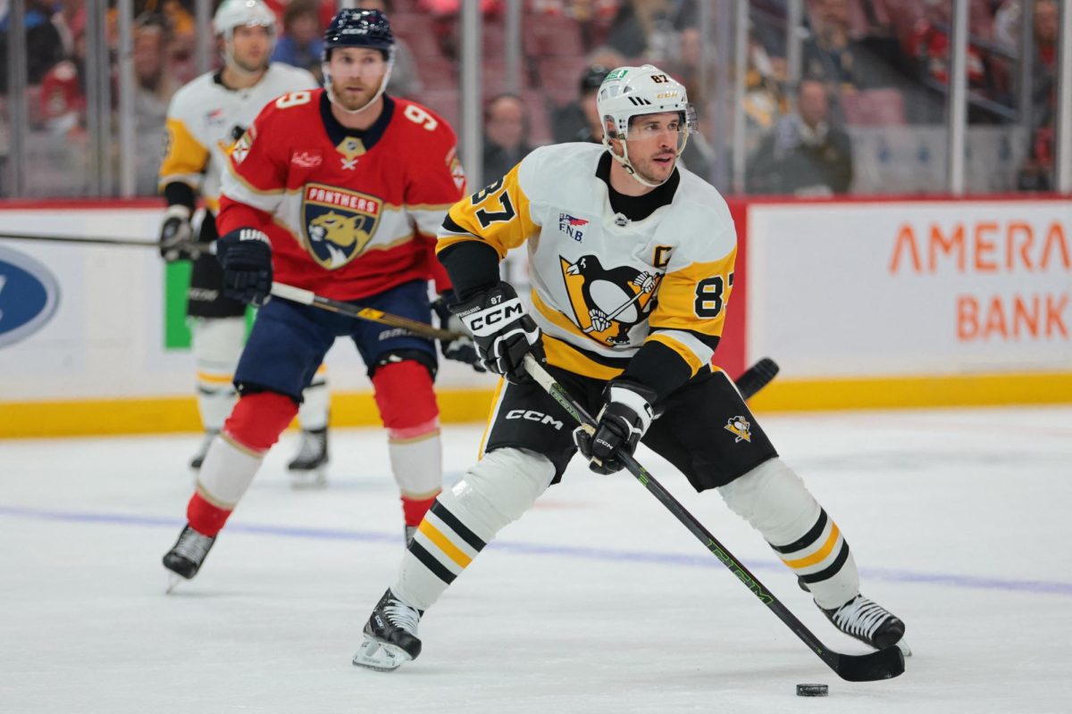 Oct 23, 2025; Sunrise, Florida, USA; Pittsburgh Penguins center Sidney Crosby (87) moves the puck against the Florida Panthers during the first period at Amerant Bank Arena. Mandatory Credit: Sam Navarro-Imagn Images