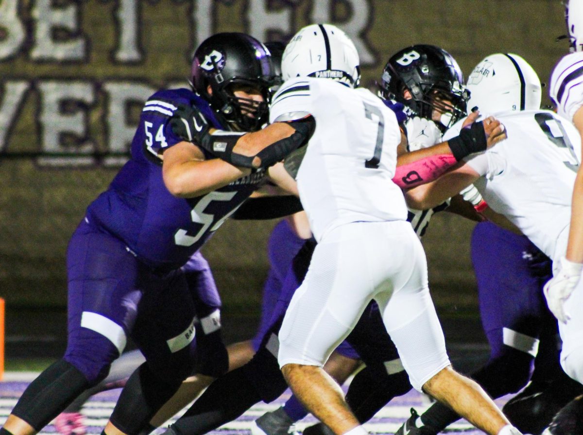 Senior Nick Huschak sets a block on  a player from Upper St. Clair.