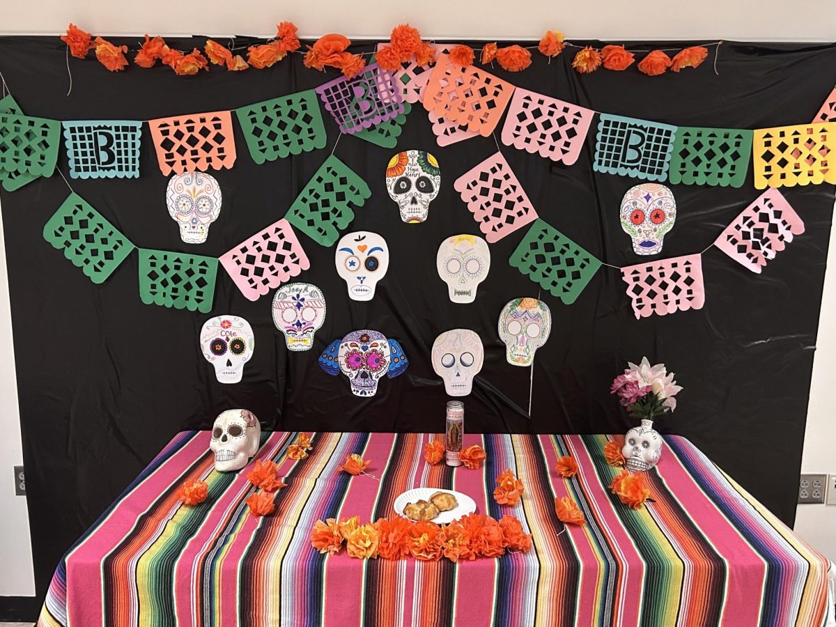 Pittsburgh artist Maggie Negrete helps Spanish students build an ofrenda.
