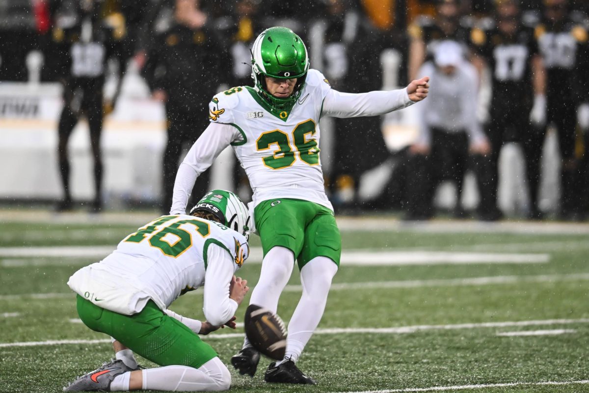 Nov 8, 2025; Iowa City, Iowa, USA; Oregon Ducks kicker Atticus Sappington (36) kicks a field goal as punter James Ferguson-Reynolds (46) holds during the second quarter against the Iowa Hawkeyes at Kinnick Stadium. Jeffrey Becker-Imagn Images