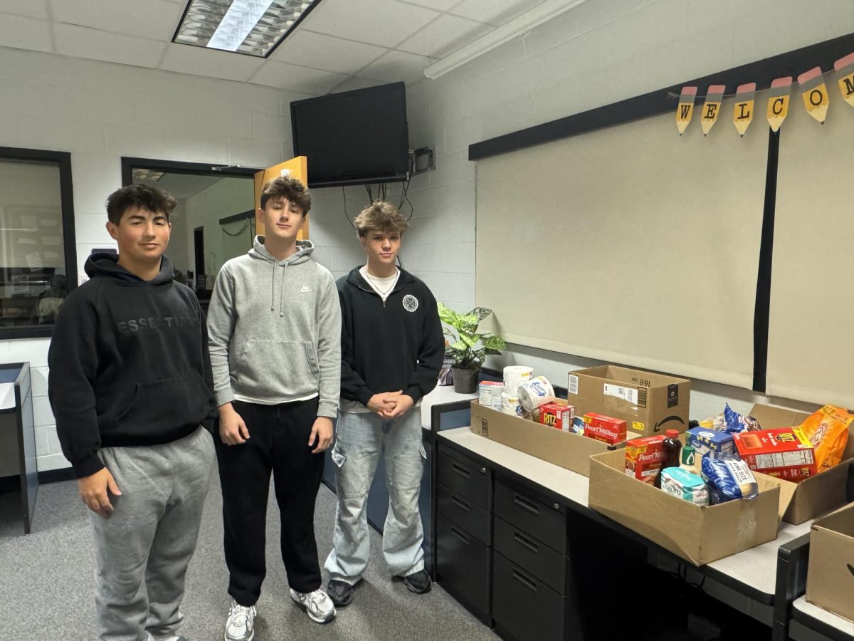 Students in teacher Michelle Kilburn's class display some of the food that has been donated at Baldwin High School. 