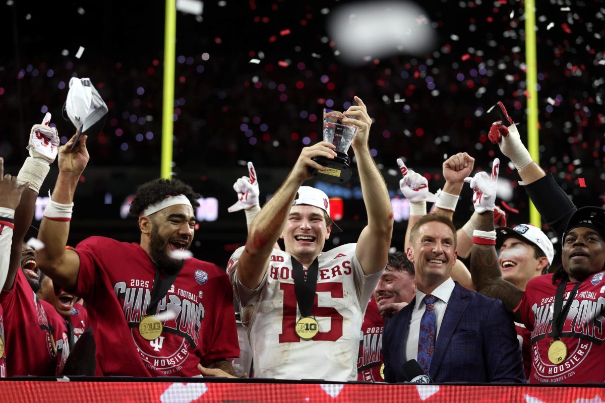 Dec 6, 2025; Indianapolis, IN, USA; Indiana Hoosiers quarterback Fernando Mendoza (15) celebrates with the MVP trophy after defeating the Ohio State Buckeyes in the 2025 Big Ten championship game at Lucas Oil Stadium. Mandatory Credit: Trevor Ruszkowski-Imagn Images