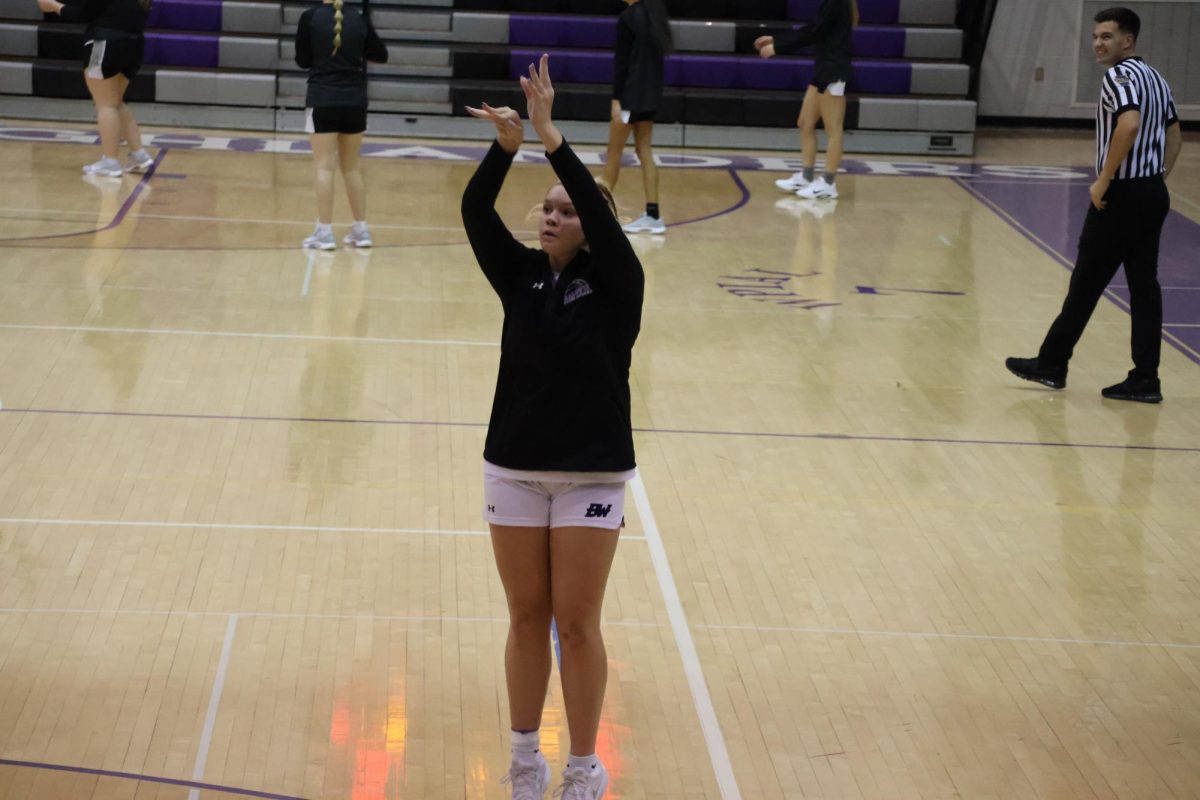 Sophomore Natalya Brisco takes warm up shots before Monday's game.