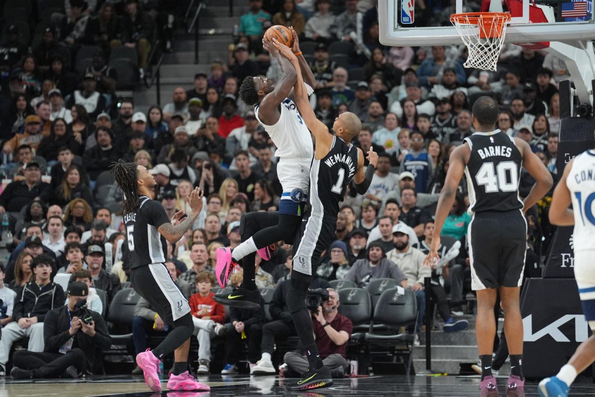 Jan 17, 2026; San Antonio, Texas, USA; San Antonio Spurs forward Victor Wembanyama (1) fouls Minnesota Timberwolves guard Anthony Edwards (5) in the second half at Frost Bank Center. Mandatory Credit: Daniel Dunn-Imagn Images