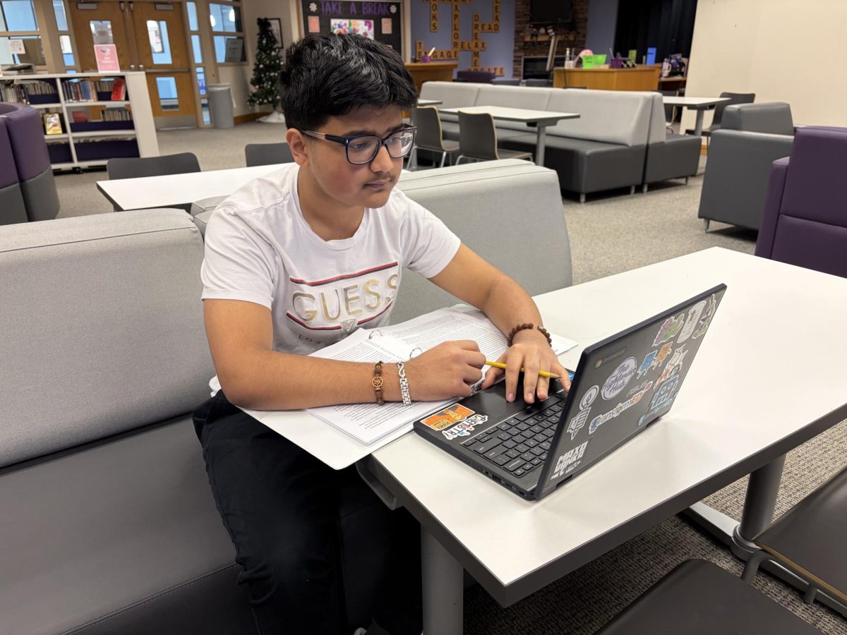 Sophomore Annjal Parajuli studies his case and writes notes for Mock Trial.