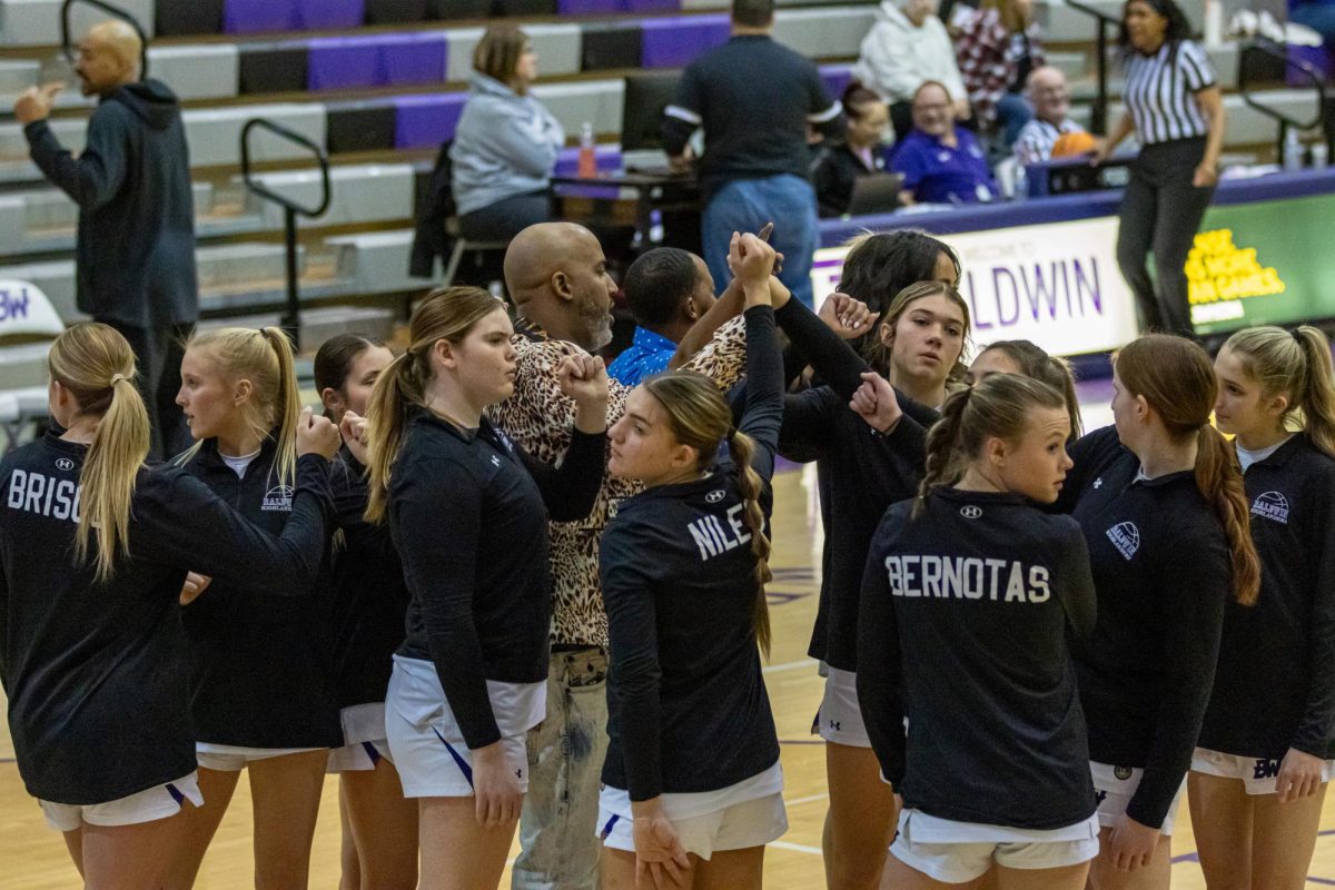 The girls basketball team huddles up before the game against Uniontown.