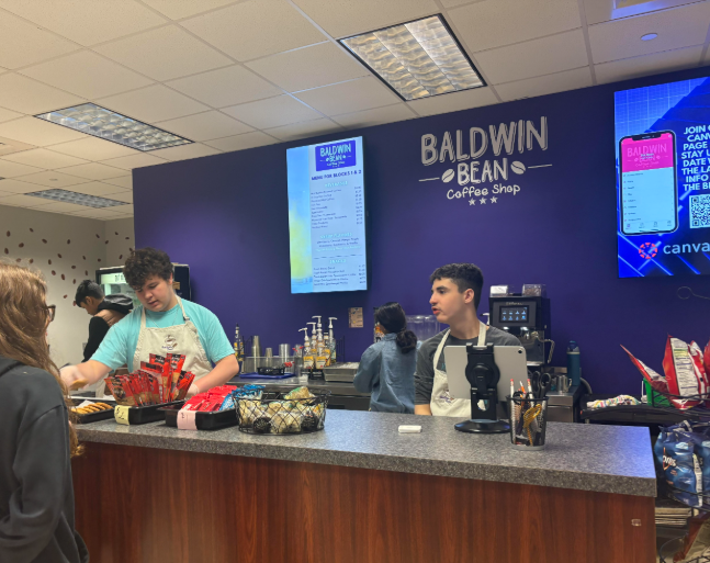 Freshman Mayson Wright and junior Max Attenburger work at the Baldwin Bean.