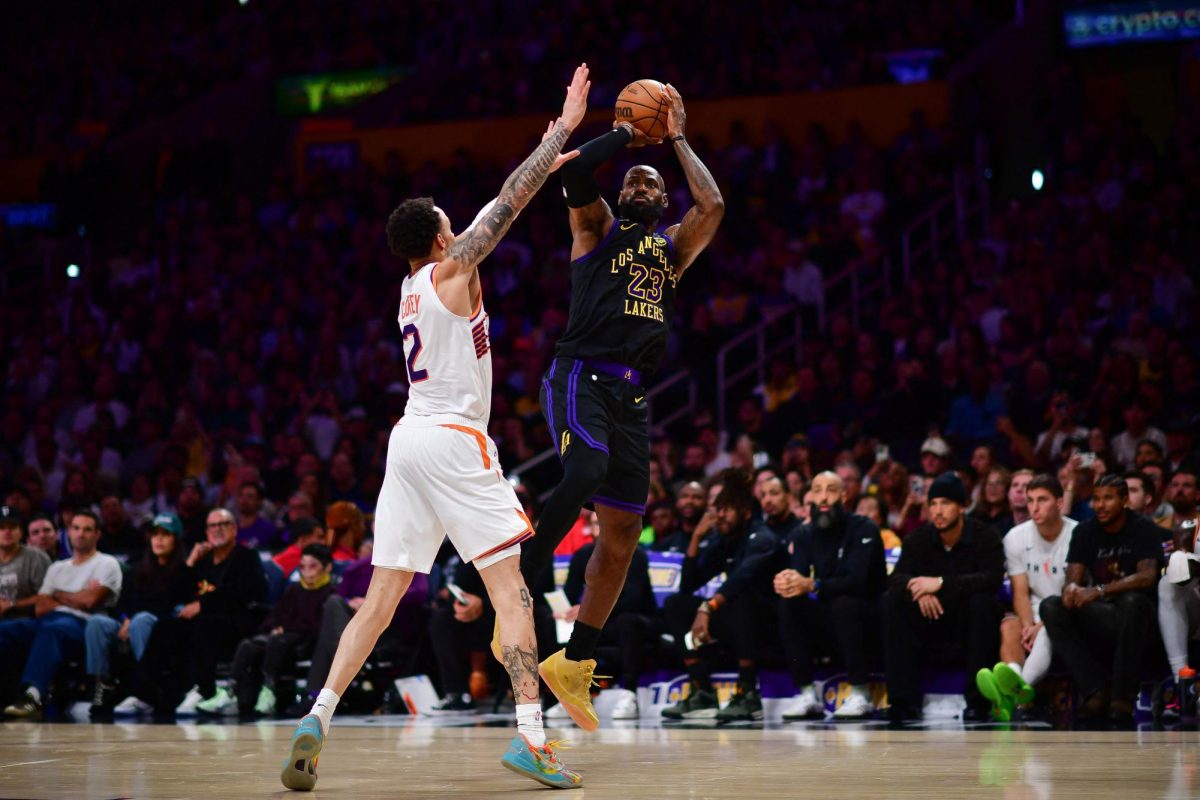 Apr 10, 2026; Los Angeles, California, USA; Los Angeles Lakers forward LeBron James (23) shoots against Phoenix Suns guard Amir Coffey (2) during the second half at Crypto.com Arena. Mandatory Credit: Gary A. Vasquez-Imagn Images