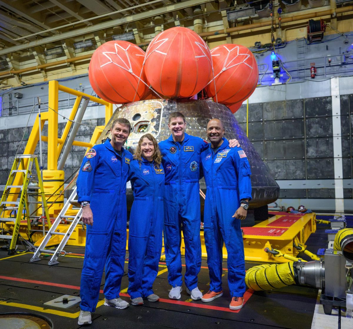 Artemis II mission's NASA astronauts Reid Wiseman and Christina Koch, Canadian Space Agency (CSA) astronaut Jeremy Hansen and NASA astronaut Victor Glover pose for a group photo after viewing the Orion spacecraft in the well deck of USS John P. Murtha after it was recovered in the Pacific Ocean off the coast of California April 11, 2026.  NASA/Bill Ingalls/Handout via REUTERS