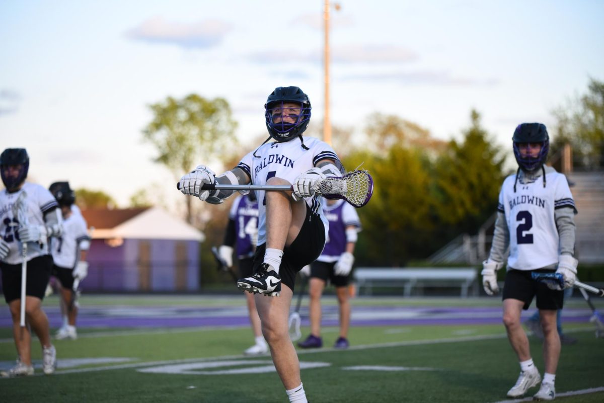 Senior Josh Staudt warms up with the team before the game starts.