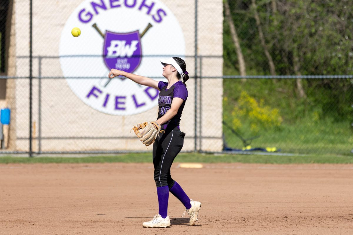 Senior Jordan Gerendash throws the ball to first base during warmups in a Apr. 22 game against Trinity,