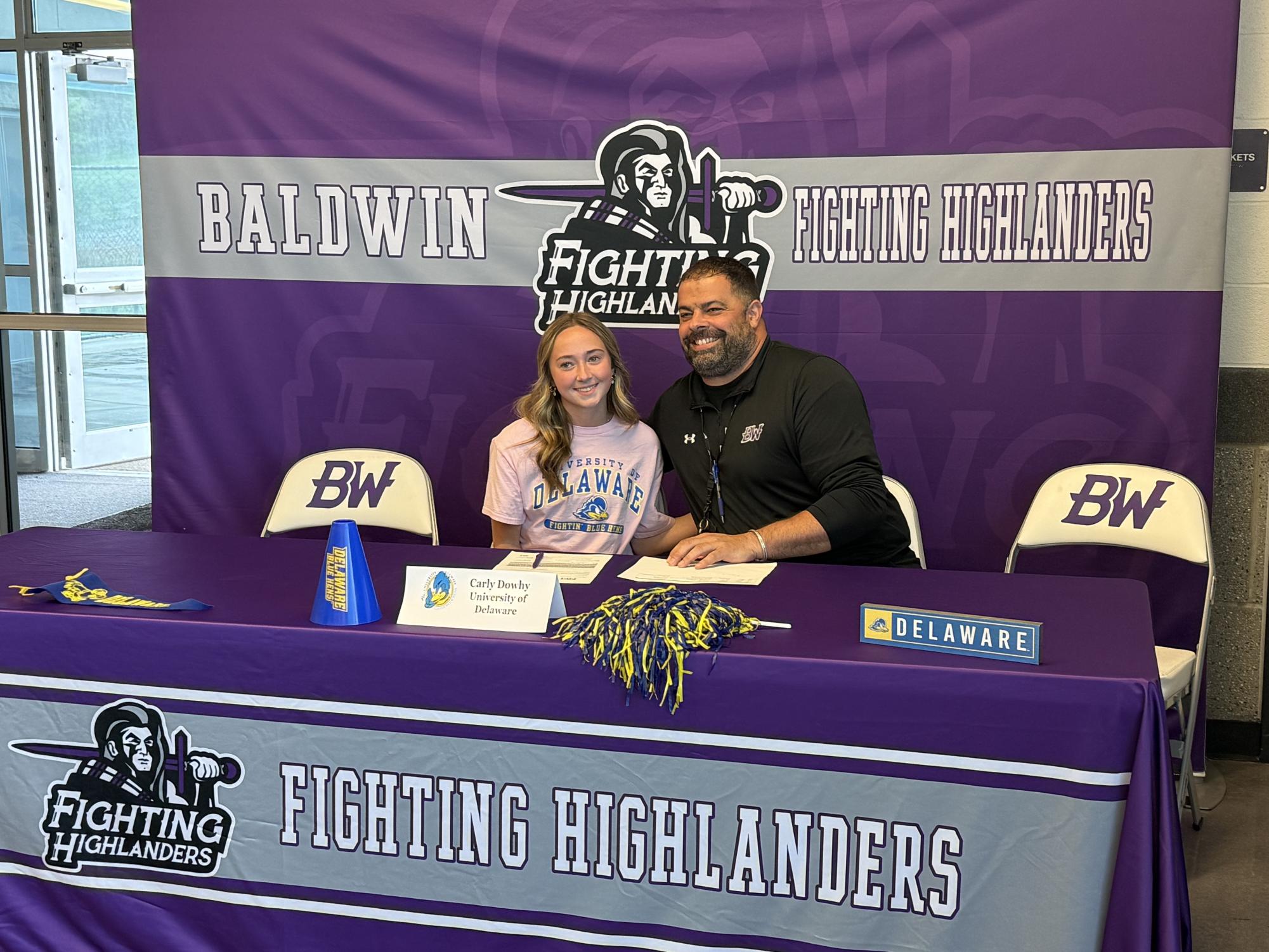 Senior Carly Dowhy signs to cheer at the University of Delaware.